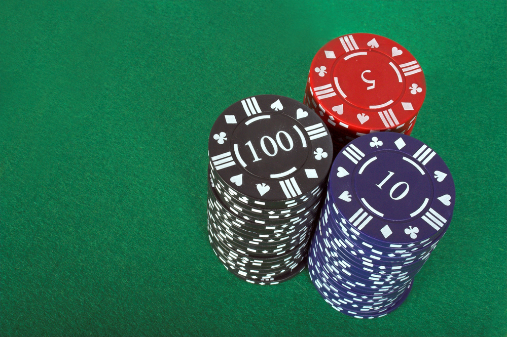 casino chips over a green felt background